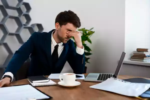 Tired man looking at solar website performance.
